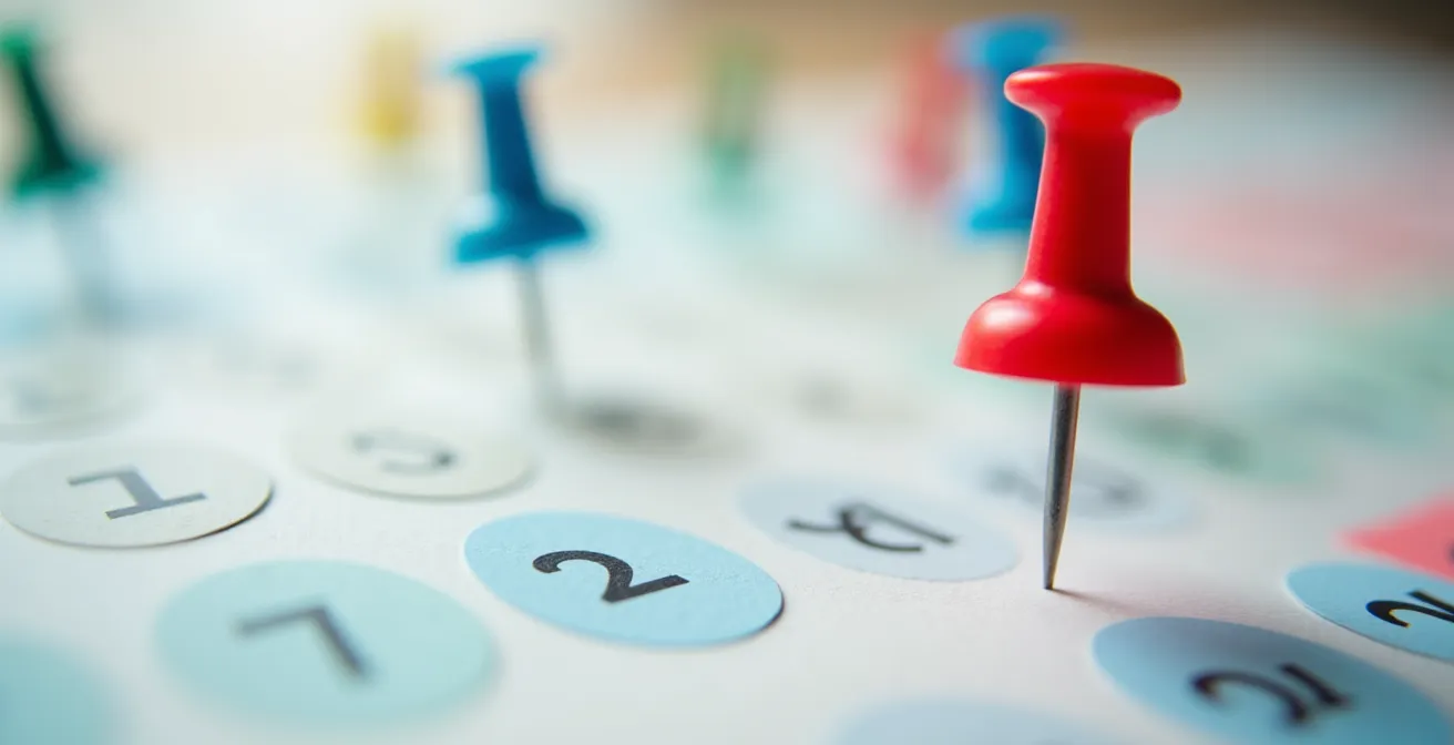 Vue macro d'un calendrier avec marqueurs colorés sur les dates importantes du déménagement